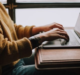 person sitting front of laptop