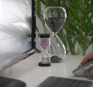 clear hour glass on white table