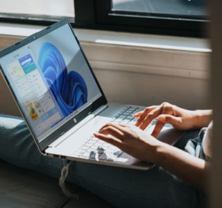 person using Windows 11 computer on lap