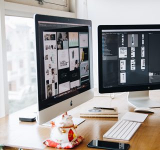 Silver Imac on Top of Brown Wooden Table