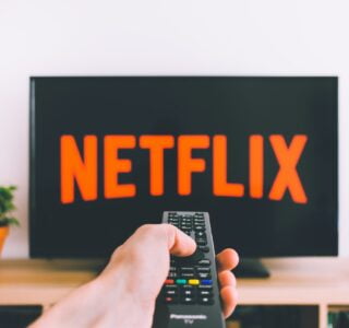 Free Person Holding a Remote Control Stock Photo