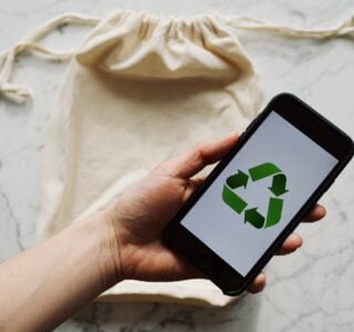 Free Faceless person showing recycle symbol on mobile phone screen Stock Photo