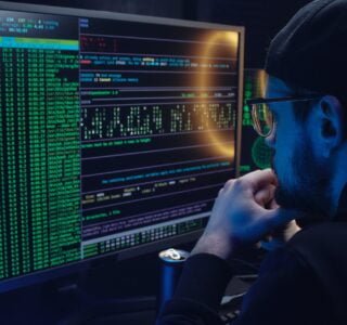 Free A Man Looking at a Computer Screen with Data Stock Photo