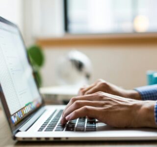 person typing on silver Macbook