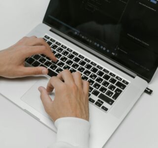 Free Hands on a Laptop Keyboard Stock Photo