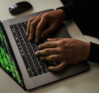 crop-cyber-spy-hacking-system-while-typing-on-laptop