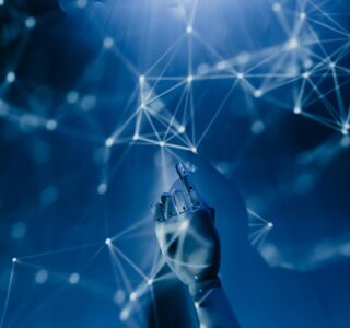 Free A robotic hand reaching into a digital network on a blue background, symbolizing AI technology. Stock Photo