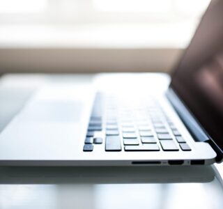 Free Elegant side view of a laptop on a glossy table with natural lighting indoors. Stock Photo