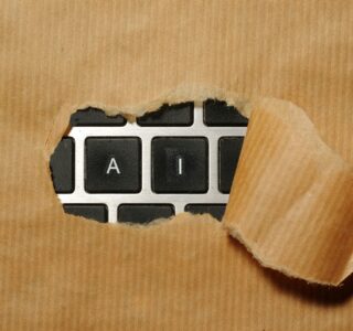 A piece of cardboard with a keyboard appearing through it