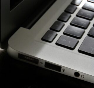 Free Detailed view of a silver laptop showing keyboard and multiple ports. Stock Photo
