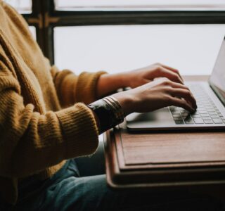 person sitting front of laptop