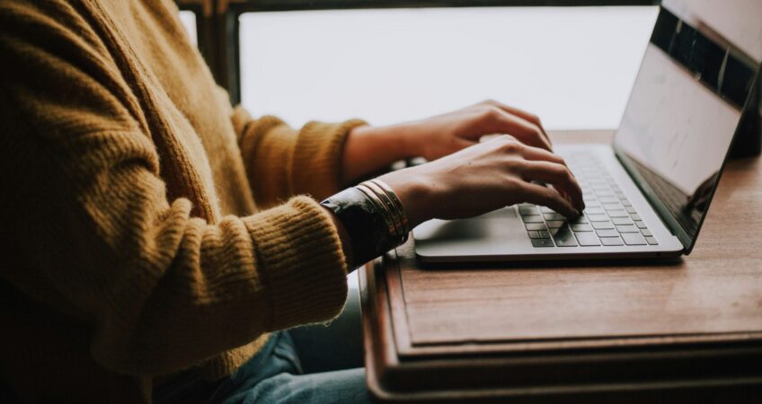 person sitting front of laptop