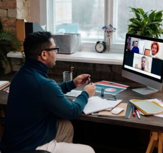 teacher-video-calling-with-his-students-using-a-computer